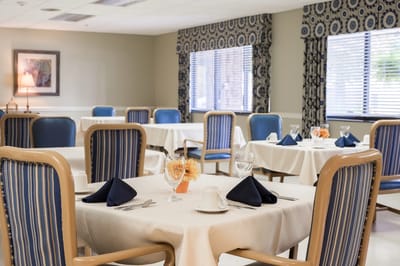 Dining area with set tables and floral decor