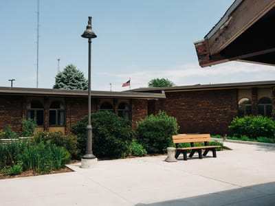 Outdoor seating area with greenery and flag