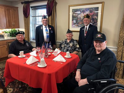 Residents celebrating at a dining table with decorations