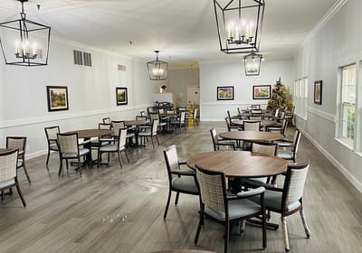 Dining area with tables and chairs set for residents