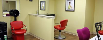 Interior view of a salon with red chairs