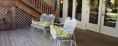 Outdoor seating area with two chairs on a wooden deck