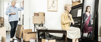 Residents packing boxes in a bright room