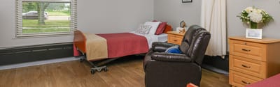 Cozy private resident room with bed and furnishings