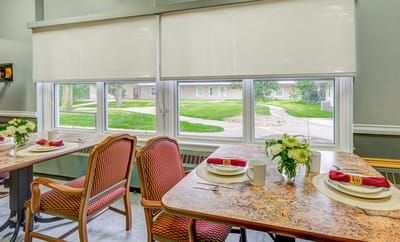 Dining area with neatly arranged tables and flower centerpieces