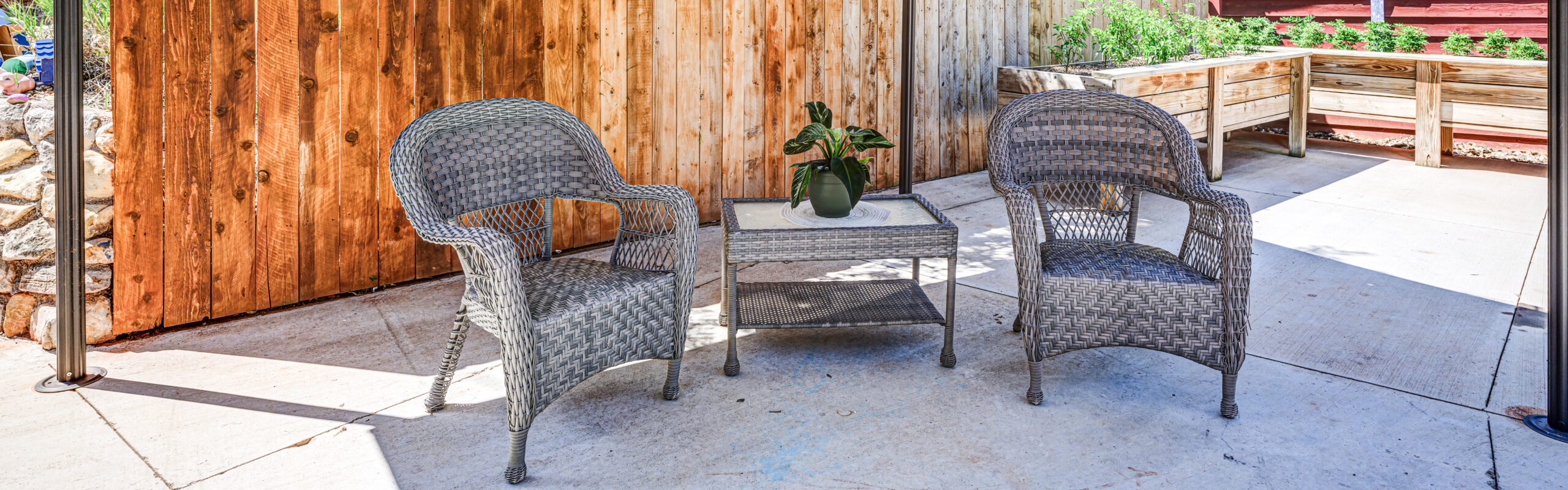 Outdoor seating area with wicker chairs and plants