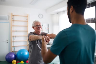 A resident and staff member engaged in an exercise session