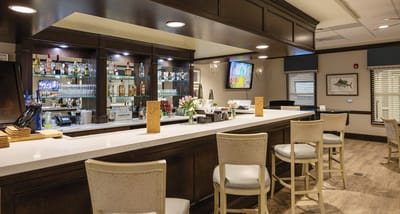 Interior view of a bar area with seating and drinks displayed