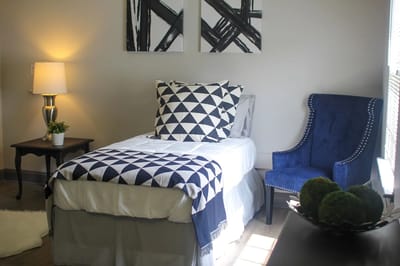 Cozy resident room with a bed and armchair
