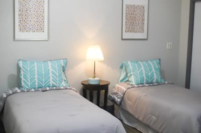 Two twin beds in a cozy room setting.