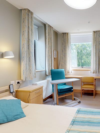 Cozy resident room with a bed and seating area