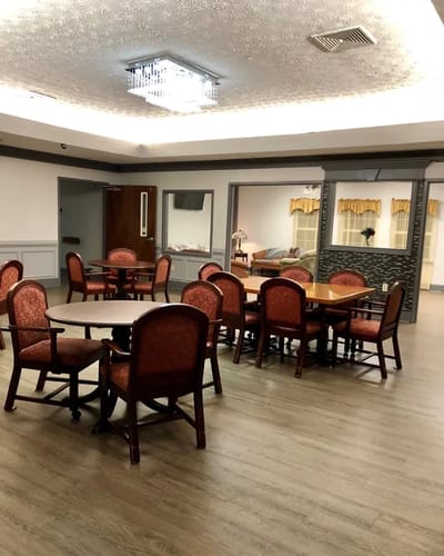 Dining area with tables and chairs set up for residents.