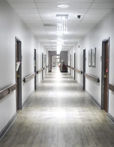 A well-lit hallway in a nursing home facility.