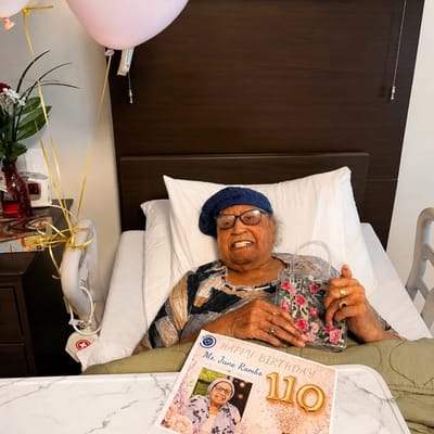 Resident celebrating her 110th birthday with balloons.