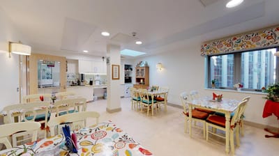 Bright dining area with colorful tables and chairs.