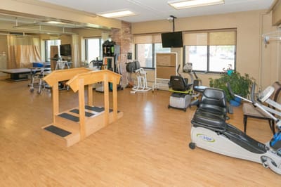 Therapy room with exercise equipment and aids.