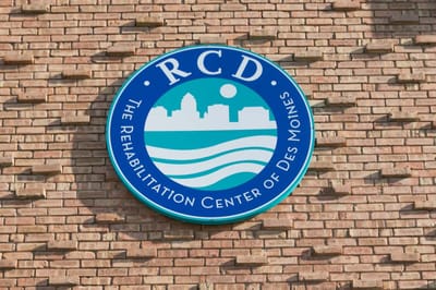 Facility logo on a brick wall