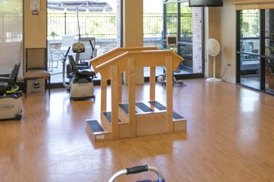 Rehabilitation gym with exercise equipment and steps