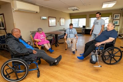Residents and staff engaged in an exercise activity.