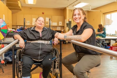 A staff member and a resident in a rehabilitation setting.
