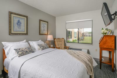 Cozy bedroom with bedside lamp and art