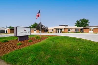 Exterior view of the assisted living facility with signage.