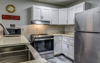 Kitchen area with appliances and cabinets