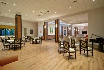 Dining area with tables and chairs.