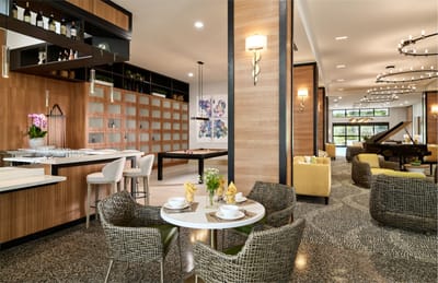 Dining area with tables and chairs in a modern setting.