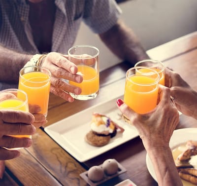 Residents enjoying drinks together at a table.