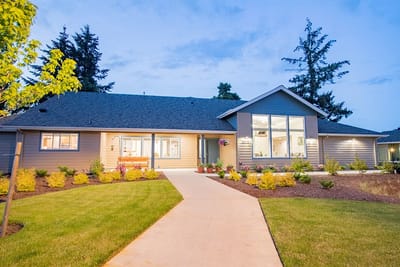 Exterior view of McKenzie Living facility at dusk