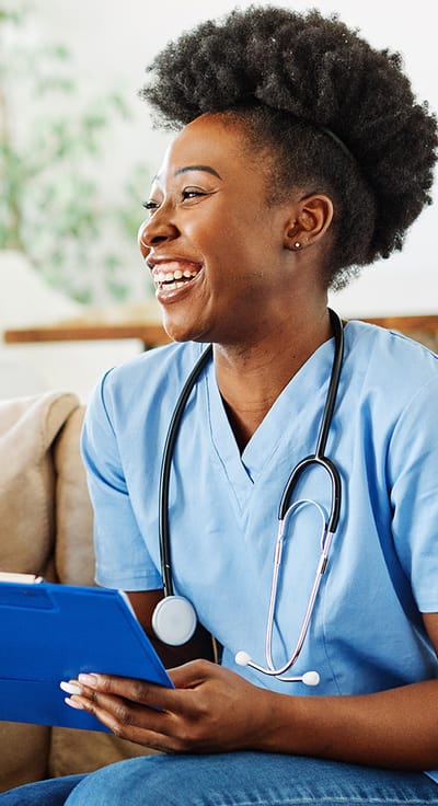 Smiling nurse with a stethoscope and clipboard