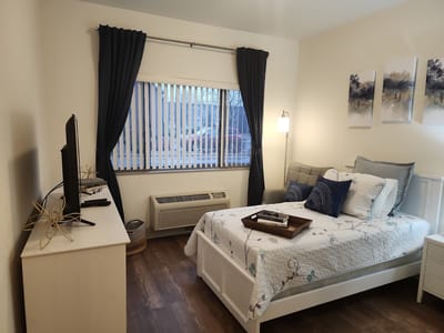 Cozy resident room with a bed and sitting area