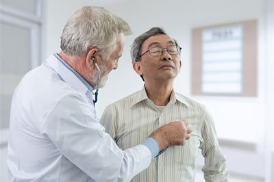 Doctor examining a senior patient in a clinic