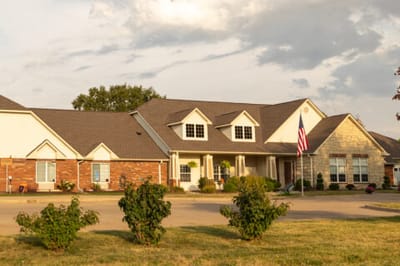 Exterior view of a senior living facility with landscaping