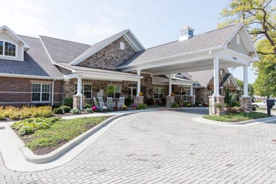 Exterior view of a senior living facility with garden