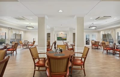 Bright dining area with tables and chairs arranged