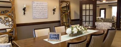Cozy common area with dining table and floral arrangements