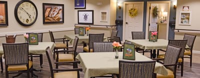 Dining area with tables and flowers arranged.