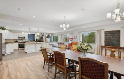 Bright common area with dining table and kitchen access