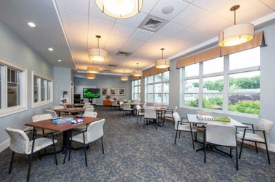 Bright common area with tables and chairs set up