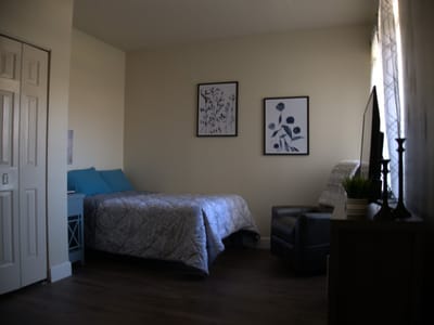 Cozy resident bedroom with light decor and furniture