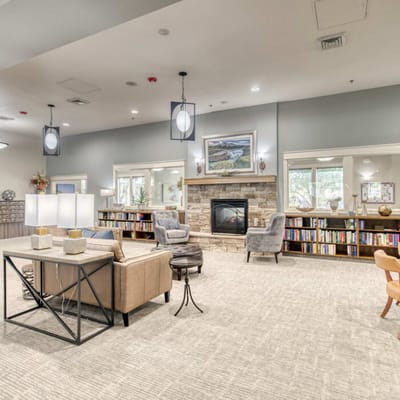 Bright interior common area with seating and bookshelves
