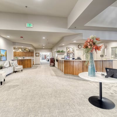 Lobby area with seating and a floral arrangement