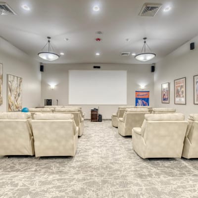 Interior view of a cozy theater room with recliners