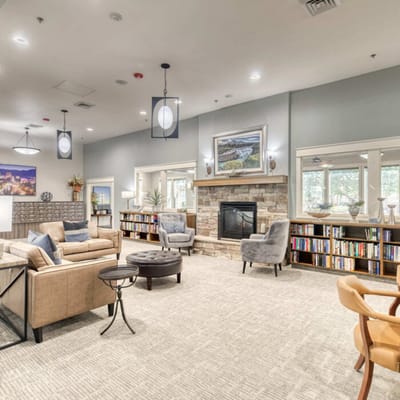 Interior of a cozy common area with seating and bookshelves
