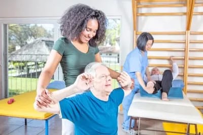 Therapist assisting a senior during a rehabilitation session