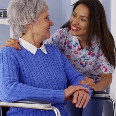 Crowne Health Care of Fort Payne, Nursing Home in Fort Payne, AL — Caregiver interacting with a smiling elderly resident