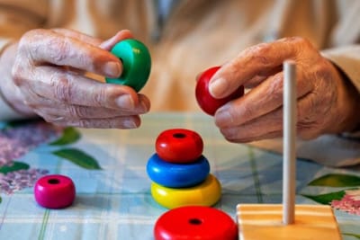 Hands of a resident engaging in a stacking game