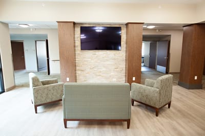 Interior view of a lounge area with seating and a TV
